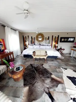 a bedroom with a large bed in a room at hippomoon lodge game reserve in Hoedspruit
