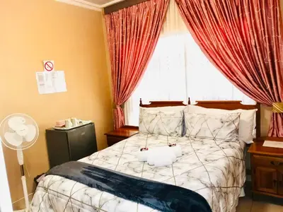 a bedroom with a bed with a stuffed animal on it at Erins Haven - Polokwane in Polokwane
