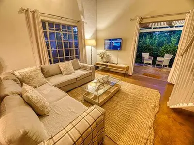 a living room with a couch and a table at Kruger park House in Hazyview