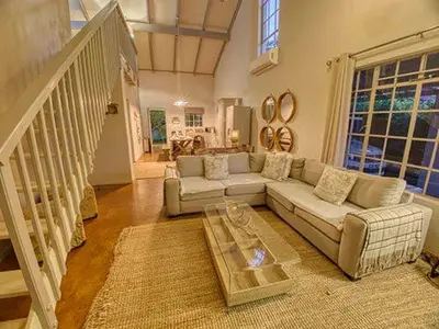 a living room with a couch and a coffee table at Kruger park House in Hazyview