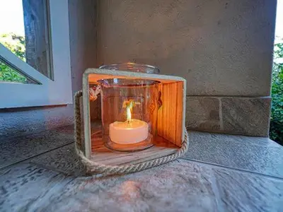 a candle in a glass lantern sitting on a porch at Kruger park House in Hazyview