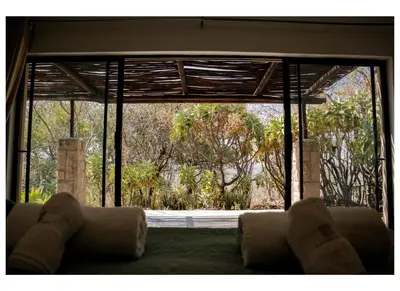 a living room with a large glass door to a yard at Elements Private Golf Villa 295 in Mabula