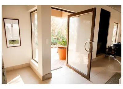 a glass door leading into a living room at Elements Private Golf Villa 295 in Mabula