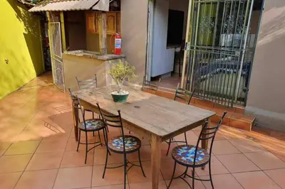a wooden table and chairs with a potted plant on it at GILLFORD GALLERY ACCOMMODATION in Benoni