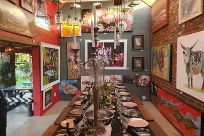 a long dining room with a long table with plates at GILLFORD GALLERY ACCOMMODATION in Benoni