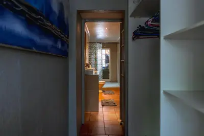 a hallway leading into a room with a bathroom at GILLFORD GALLERY ACCOMMODATION in Benoni
