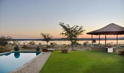 a resort with a pool with a view of the water at Kameeldrift Waterfront Estate & Resort in Brits