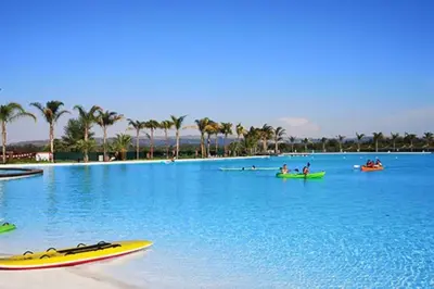 a large swimming pool with people on kayaks in the water at Insaka 2 The Blyde Crystal Lagoon Experience in Pretoria