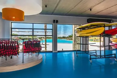 a room with a pool with chairs and a slide at Insaka 2 The Blyde Crystal Lagoon Experience in Pretoria