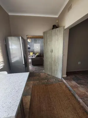 a kitchen with a sliding door in a room at Ducks Nest in Malelane
