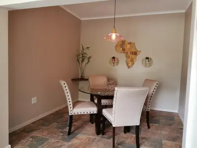 a dining room with a table and chairs at Ducks Nest in Malelane