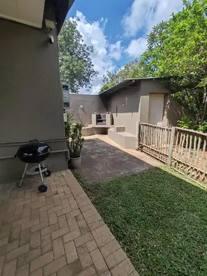 a barbecue grill sitting on the side of a house at Ducks Nest in Malelane