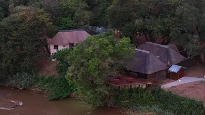 an aerial view of a house next to a river at Bushriver Lodge in Mica