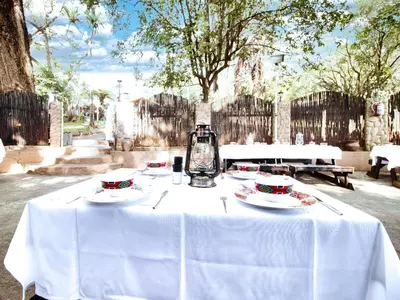 a white table with plates and a lantern on it at Hotel 247 @ White River in White River
