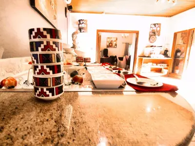 a kitchen with a counter top and a living room at Hotel 247 @ White River in White River