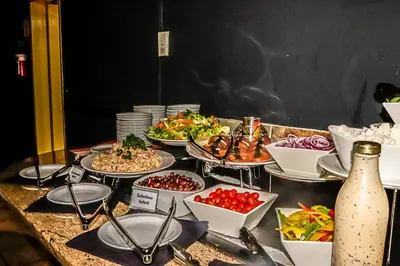 a buffet with many plates of food on a table at Hotel 247 @ White River in White River