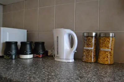 a counter with three jars of granola and a toaster at The Open Door Guest Suite in Modimolle