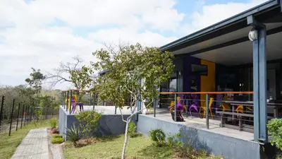 a building with a playground in front of it at SleepOver Kruger Gate in Skukuza