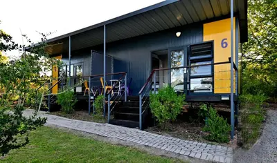 a house with a yellow and blue house at SleepOver Kruger Gate in Skukuza