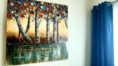 a painting of trees hanging on a wall at NST City Apartments @ 9 Joubert in Nelspruit