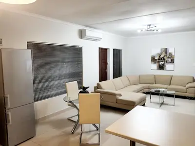 a living room with a couch and a table at NST City Apartments @ Casalinga Villa in Nelspruit