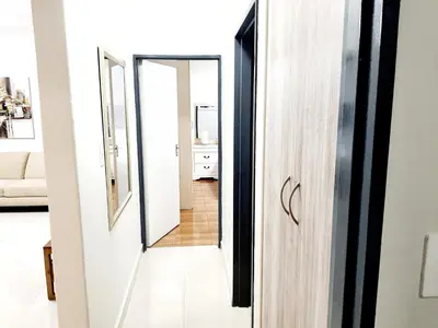 a hallway leading into a living room with a mirror at NST City Apartments @ Casalinga Villa in Nelspruit