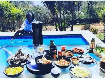 a table with food on it next to a pool at Patogeng Self Catering - Da Gama Dam view in White River