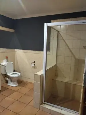 a bathroom with a shower and a toilet at Patogeng Self Catering - Da Gama Dam view in White River
