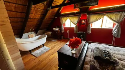 a bathroom with a bath tub and a bed at Farm Vibes Guest House in Brits