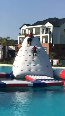 two people on a inflatable slide in a swimming pool at The Blyde Riverwalk Estate, Crystal Lagoon, Pretoria east in Pretoria