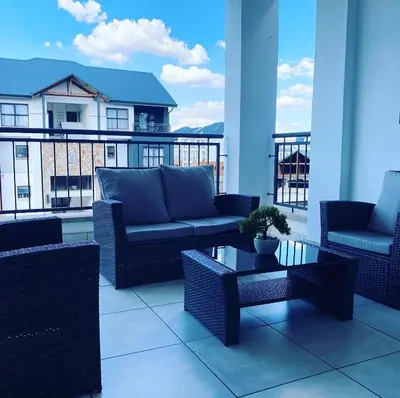 a balcony with couches and a coffee table on a building at The Blyde Magna Host Luxury Apartments in Pretoria