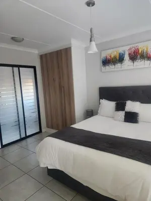 a bedroom with a large bed and a window at The Blyde 1317 in Pretoria