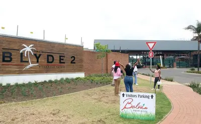 a group of people walking in front of a building at The Blyde 1317 in Pretoria