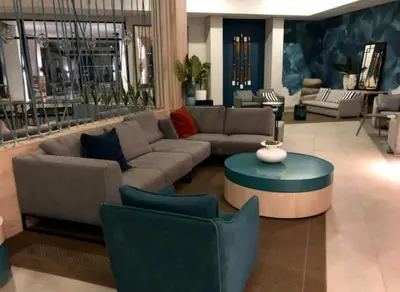 a living room with a couch and a table and chairs at The Blyde 1317 in Pretoria