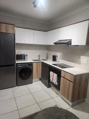 a kitchen with a sink and a dishwasher at The Blyde 1317 in Pretoria