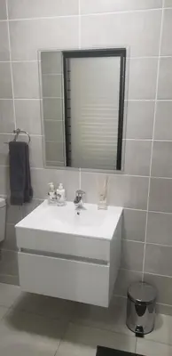 a bathroom with a white sink and a mirror at The Blyde 1317 in Pretoria