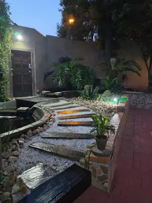 a garden with a walkway with rocks and plants at Halfway Gardens Home in Midrand