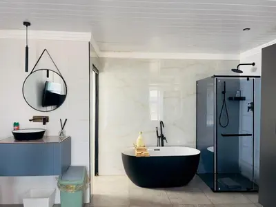a bathroom with a large tub and a shower at ANG COMSAT Guesthouse in Northam