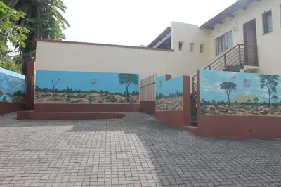 a building with paintings on the side of it at Lalamnandzi3 in Nelspruit