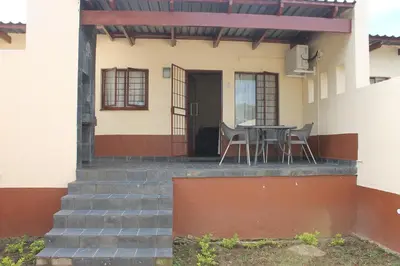 a house with a table and chairs on the porch at Lalamnandzi3 in Nelspruit