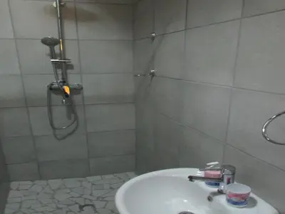 a bathroom with a shower and a white sink at Lalamnandzi1 in White River