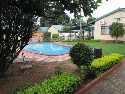 a swimming pool in the yard of a house at Lalamnandzi1 in White River