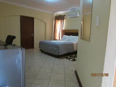 a hotel room with a bed and a window at Lalamnandzi2 in White River