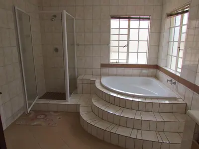 a large bathroom with a tub and a shower at Lalamnandzi2 in White River