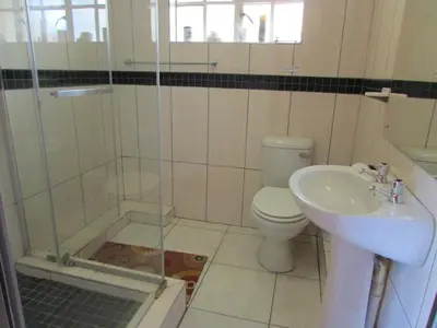 a bathroom with a shower and a toilet and a sink at Lalamnandzi2 in White River