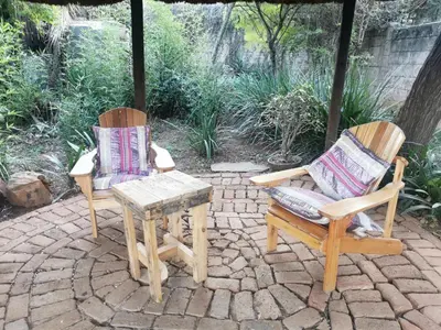 two chairs and a table on a patio at Sun Deck Lodge in Hartbeespoort