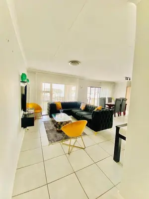 a living room with a couch and a table at The Blyde Boutique Apartments in Pretoria