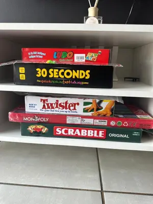 a shelf with some board games on it at The Blyde Boutique Apartments in Pretoria