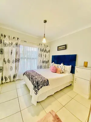a bedroom with a bed with a zebra blanket on it at The Blyde Boutique Apartments in Pretoria