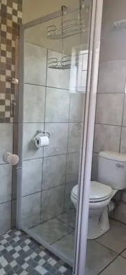 a bathroom with a shower with a toilet at Rand Self-catering Accommodation in Carolina